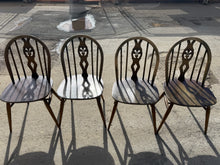 Load image into Gallery viewer, A charming set of 4 vintage Ercol Blue Label Plume of Feather dining chairs. Each chair is structurally sound and ready for use. As pre-loved pieces, they display natural wear and minor surface marks consistent with age. These character-filled details can be easily refreshed with dark wax to restore their warm patina and enhance the wood grain.
Delivery Available
Overall Dimensions
approx : 43cm wide x 41cm deep x 82.5cm high