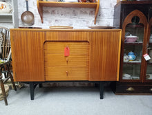 Load image into Gallery viewer, A classic teak sideboard by CWS Ltd, built to last. This piece combines timeless design with practical storage—two cupboards with shelving and four generous drawers provide ample space for dining essentials or living room organisation. Well-maintained and structurally sound, it bears the gentle patina of vintage use with only minor surface marks. A versatile addition to period or contemporary interiors.
Delivery Available
Overall Dimensions
137cm wide x 43cm deep x 85cm high