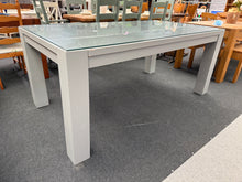 Load image into Gallery viewer, This expertly crafted solid oak dining table has been repainted by its previous owners in a stylish grey hue. A removable glass top adds convenience, while the legs can be easily detached for hassle-free moving.
180cm long x 99.5cm wide x 78cm high
DELIVERY AVAILABLE      
For our other items see our website https://fossewayfurniture.co.uk
collection from our shop at cv36, our collection zone at bs36 or otherwise delivery is available