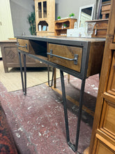 Load image into Gallery viewer, A characterful industrial desk combining metal framework with wood surfaces. Structurally sound with authentic patina marks that enhance its vintage appeal. Features two practical storage drawers and robust construction. Please note: one leg requires welding or similar repair to restore full stability. Ideal for those seeking authentic industrial style with character.
Delivery Available
Overall Dimensions
112cm wide x 46cm deep x 80cm high