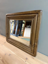Load image into Gallery viewer, A charming small mirror crafted from solid pine, featuring elegant bevelled edges that catch the light beautifully. This piece shows gentle signs of age and use, adding character and authenticity. Structurally sound and in good working condition, it's ready to bring warmth and vintage appeal to any room.
Delivery Available
Overall Dimensions
57cm wide x 47cm high 
