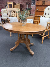 Load image into Gallery viewer, This authentic antique pine table combines timeless charm with practical durability. Structurally sound and well-preserved for its age, it bears the gentle patina of years of use—a few natural marks that add character rather than detract from its appeal. Versatile enough to serve as a dining table, though it truly shines as a distinctive side table or accent piece.
Delivery Available
Overall Dimensions
102cm wide x 69cm deep x 69cm high