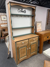Load image into Gallery viewer, This beautiful oak dresser has been transformed into a perfect coffee station. It offers plenty of storage with 2 shelves and 5 hooks in the top area, plus 2 drawers and a double cupboard below. The dresser has been carefully sanded and waxed, with a bright white backboard and interior, finished with green edges. It splits into two parts for easy moving.
Overall Dimensions
92cm wide x 41cm deep x 180cm high
DELIVERY AVAILABLE      
For our other items see our website https://fossewayfurniture.co.uk
col