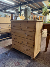 Load image into Gallery viewer, This solid pine chest of drawers showcases beautiful natural wood grain after being stripped back to bare wood. Four spacious dovetail-jointed drawers provide ample storage with smooth operation. Structurally sound and well-maintained, it displays only minor surface marks consistent with use. A protective coat of wax or finish is recommended to enhance durability and bring out the wood's character. An authentic piece with timeless appeal, ideal for adding warmth to any bedroom or living space.
Delivery Ava