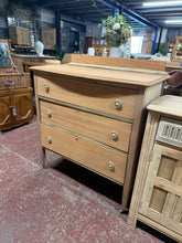 Load image into Gallery viewer, This stripped mahogany chest of drawers showcases beautiful natural wood grain after being carefully restored to bare wood. Three spacious dovetail-jointed drawers provide ample storage with traditional craftsmanship. Structurally sound and ready for finishing—a light coat of wax or oil will enhance the wood and provide lasting protection. Perfect for those who appreciate authentic period furniture with character and quality construction.
Delivery Available
Overall Dimensions
92cm wide x 48cm deep x 102c