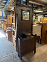 Load image into Gallery viewer, This sturdy oak hall stand is in good condition and includes 6 hooks and a small storage drawer. While it may show signs of use, such as minor marks and a broken hook, these flaws are not significant. The stand offers plenty of storage space for items like umbrellas, making it practical and functional.
Overall Dimensions
68cm wide x 28cm deep x 188cm high
DELIVERY AVAILABLE
HAVE THIS PAINTED A COLOUR OF YOUR CHOICE FOR AN EXTRA £70 OR COMPLETELY STRIPPED BACK FOR £80
For our other items see our we