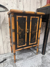 Load image into Gallery viewer, Discover the timeless elegance of this authentic bamboo cupboard, a pre-loved treasure that brings oriental charm and natural warmth to your space. This piece features practical double-door storage perfect for displaying treasures or concealing everyday items. Well-maintained and ready to become a cherished focal point in your home. Please note it has one missing handle.
Delivery Available
Overall Dimensions
51.5cm wide x 30.5cm deep x 76.5cm high
