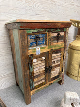 Load image into Gallery viewer, A striking reclaimed sideboard that combines character with practicality. This two-door piece features structural integrity and excellent condition throughout, with two short drawers positioned above a double cupboard housing an internal shelf. The weathered finish and authentic patina make it a bold focal point for living rooms, dining spaces, or hallways. Perfect for storing tableware, linens, or decorative displays whilst adding timeless appeal to any interior scheme.
Delivery Available
Overall Dimensi