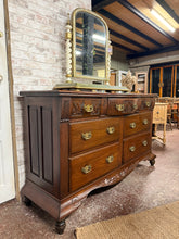 Load image into Gallery viewer, A substantial mahogany chest of drawers with authentic character. Structurally sound and in good overall condition, this piece features seven dovetail-jointed drawers—three shallow and four deep—offering generous storage. The used finish includes natural patina, minor marks, and a small crack to the top surface, adding to its vintage appeal. An impressive focal point for period properties and traditional interiors.
Delivery Available
Overall Dimensions
150cm wide x 54.5cm deep x 91cm high