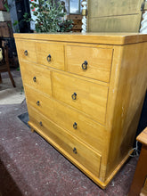 Load image into Gallery viewer, Transform your space with this substantial oak chest of drawers—a versatile storage solution that adapts to your vision. Seven thoughtfully sized drawers, including three compact, two standard, and two large, provide flexible organisation for any room. The frame is robust and reliable, built to serve you well for years to come. There are a few surface marks. This piece is primed for personalisation, whether you envision a fresh coat of paint or a natural stain refresh.
Overall Dimensions
106cm wide x 46.5
