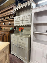 Load image into Gallery viewer, This charming shabby chic dresser in soft beige / green offers practical storage with a thoughtful design. The upper section features two cupboards above two spacious drawers, while the lower base includes a double cupboard for additional capacity. Structurally sound and well-maintained with only minor cosmetic marks, it's perfect for dining rooms or bedrooms. The piece conveniently separates into two parts for hassle-free moving and positioning.
Delivery Available
Overall Dimensions
94cm wide x 49cm dee