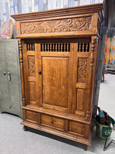 Load image into Gallery viewer, This beautiful hardwood carved wardrobe combines timeless craftsmanship with practical storage solutions. Structurally sound and in overall great condition, it features one spacious hanging rail ideal for your coats and dresses, plus a convenient drawer for additional storage. While it shows a few minor marks, these add character without detracting from its charm. Please note, this wardrobe is very heavy, reflecting its solid, high-quality construction that ensures durability for years to come. Bring elegan