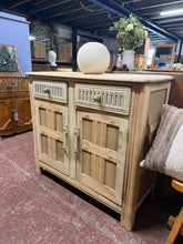 Load image into Gallery viewer, A beautiful stripped oak sideboard revealing the wood's natural grain and character. Features two dovetail-jointed drawers providing secure storage, positioned above a spacious double cupboard with internal shelf. The bare wood finish offers authentic appeal and allows you to customise the look with your choice of wax, oil, or stain. Ideal for adding warmth and craftsmanship to any room.
Delivery Available
Overall Dimensions
91cm wide x 39.5cm deep x 81cm high