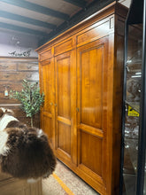 Load image into Gallery viewer, A spacious triple wardrobe in cherry wood, built to last. Structurally sound with good overall condition, showing minor wear consistent with use. Features one double and one single cupboard, each with hanging rail and shelves for versatile storage. Fully dismantles into manageable sections for easy transport and installation. Delivered or collected in flat-pack form.
Delivery Available
Overall Dimensions
202.5cm wide x 61cm deep x 210cm high