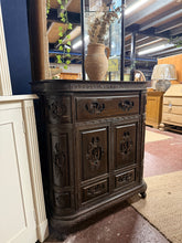 Load image into Gallery viewer, A beautifully carved ornate drinks cabinet with timeless character. Structurally sound and in very good condition, featuring minor surface marks to the top that can be improved with polishing. Generous storage throughout: lift-up lid with pull-out trays, side cupboards with bottle holders, drawers, and a double cupboard. Clever hidden compartments add extra storage potential. Perfect for displaying glassware, spirits, and entertaining essentials with classic style.
Delivery Available
Overall Dimensio