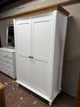 Load image into Gallery viewer, A spacious solid pine wardrobe with classic appeal. Crafted from quality pine and finished in white by previous owners, it shows minor wear that adds character—ideal for refinishing or leaving as-is. Structurally sound and well-maintained throughout. Features a single hanging rail for clothing storage. Designed to disassemble into three sections, making transport and placement straightforward. Perfect for bedrooms seeking generous storage with authentic wooden construction.
Delivery Available
Overall Dime