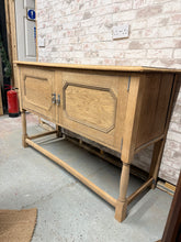 Load image into Gallery viewer, Discover the natural beauty of this stripped oak sideboard, revealing the wood's authentic character and grain. Structurally sound with minor cosmetic marks, it offers generous storage through a spacious double cupboard and arrives with its original key. The bare wood finish invites personalisation—consider applying wax or oil to enhance protection and achieve your desired aesthetic. A versatile piece that brings warmth and timeless appeal to any room.
Delivery Available
Overall Dimensions
137cm wide x 5