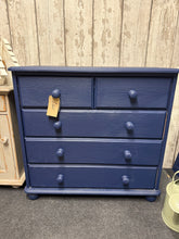 Load image into Gallery viewer, Crafted from sturdy solid pine and finished in a striking deep blue, this charming chest of drawers brings warmth and character to any room. The practical layout features two compact drawers positioned above three spacious ones, offering flexible storage solutions for everything from clothing to household essentials. A timeless piece that combines functionality with understated elegance.
Delivery Available
Overall Dimensions
84cm wide x 39cm deep x 79cm high 