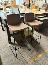 Load image into Gallery viewer, A wonderful pair of brown industrial bar stools that combine sturdy construction with timeless style. These well-maintained pieces are ideal for completing your breakfast bar setup, offering both durability and character. Whether you're furnishing a kitchen island or creating a casual dining spot, this matching set brings authentic industrial charm to your space.
Overall Dimensions
approx : 40cm wide x 40cm deep x 95cm high
DELIVERY AVAILABLE
For our other items see our website https://fossewayfur