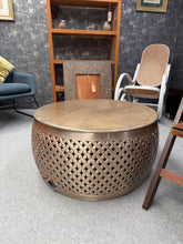 Load image into Gallery viewer, Discover the charm of this distinctive Metal Effect Coffee Table, a striking piece that blends industrial character with Moroccan-inspired design. Crafted with a warm brass coloured finish, this table brings authentic style to any living space. Minor dents and wear are present. Perfect for those who appreciate eclectic, well-travelled aesthetics, this coffee table serves as both a practical surface and a conversation starter.
Delivery Available
Overall Dimensions
79cm diameter x 40cm high
