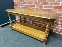 Load image into Gallery viewer, A characterful oak coffee table with timeless appeal. Structurally sound and in good condition, this piece showcases distinctive barley twist legs that add genuine character. The surface bears the honest patina of age—light marks that enhance rather than detract from its charm. A practical lower shelf provides convenient storage. Perfect for those who appreciate vintage furniture with authentic character and functionality.
Delivery Available
Overall Dimensions
90cm wide x 43cm deep x 46cm high