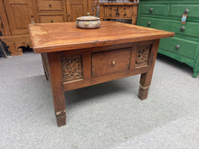 Load image into Gallery viewer, This beautiful hardwood carved coffee table is sturdy and well-maintained overall. It shows a few minor marks, but shot-blasting would restore it to like-new condition. Plus, it features a handy drawer at the front for extra storage.
Overall Dimensions
82.5cm wide x 82.5cm deep x 54cm high
DELIVERY AVAILABLE      
For our other items see our website https://fossewayfurniture.co.uk
collection from our shop at cv36, our collection zone at bs36 or otherwise delivery is available