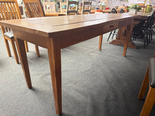 Load image into Gallery viewer, A spacious hardwood dining table built to last, offering seating for 6–8 guests with ease. The solid construction features sturdy, fixed legs and a practical front drawer for storing table linens or dining essentials. Light surface marks add character without compromising its overall good condition. Perfect for family gatherings and entertaining.
Delivery Available
Overall Dimensions
201cm long x 80.5cm deep x 81cm high