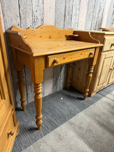 Load image into Gallery viewer, This charming solid pine washstand is sturdy and well-maintained. It shows some signs of use with minor marks, but nothing significant. It features a spacious long drawer at the front, perfect for storing your essentials.
Overall Dimensions
86cm wide x 42cm deep x 92cm high
DELIVERY AVAILABLE
HAVE THIS PAINTED A COLOUR OF YOUR CHOICE FOR AN EXTRA £60 OR HAVE IT COMPLETELY STRIPPED BACK FOR JUST £70
For our other items see our website https://fossewayfurniture.co.uk
collection from our shop a