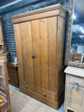 Load image into Gallery viewer, A beautiful vintage pine wardrobe that's built to last. Solid and dependable with character to spare, this piece bears the gentle marks of time that only enhance its appeal. Inside, you'll find a practical hanging rail, convenient hooks, and two spacious drawers—everything you need for organised storage. Perfect for adding authentic period charm to any bedroom.
Overall Dimensions
112cm wide x 47cm deep x 184cm high
DELIVERY AVAILABLE
For our other items see our website https://fossewayfurniture.co