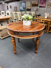 Load image into Gallery viewer, A characterful solid mango wood round dining table with authentic vintage appeal. Structurally sound and fully functional, this piece features natural patina and minor surface marks that add to its charm—easily refreshed with a light polish if desired. The gently bowed legs are entirely stable and contribute to its distinctive character. Removable legs make transport and repositioning effortless, perfect for flexible living spaces.
Delivery Available
Overall Dimensions
101cm diameter x 79cm high 