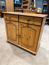 Load image into Gallery viewer, A sweet pine sideboard offering practical storage with two drawers positioned above a double cupboard featuring an internal shelf. Minor surface marks add character without detracting from its functionality or appeal. Ideal for dining rooms or living spaces where you need dependable storage with rustic charm.
Delivery Available
Overall Dimensions
89cm wide x 40cm deep x 79cm high