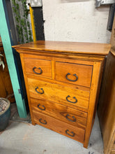 Load image into Gallery viewer, Discover the timeless appeal of this Indonesian hardwood chest of drawers—a robust piece built to last. Featuring a practical layout of two compact drawers positioned above three spacious ones, it offers generous storage for any room. While it bears the gentle patina of age with minor surface marks, its solid construction and excellent overall condition make it a wonderful addition to homes seeking authentic character and functionality.
Overall Dimensions
76cm wide x 40cm deep x 96cm high
DELIVERY AVAILA