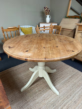 Load image into Gallery viewer, A charming two-tone round pine table with cream-painted legs. Structurally sound and in good overall condition, this piece shows honest signs of use with minor surface marks. Both the top and base would benefit from refinishing to restore their original beauty. The removable top design makes transport and rearrangement effortless. Perfect for those seeking character and practicality in a vintage dining or occasional table.
Delivery Available
Overall Dimensions
107cm diameter x 78cm high