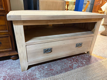Load image into Gallery viewer, A beautiful stripped oak TV unit with authentic character. This piece has been carefully restored to reveal the natural wood grain, presenting a blank canvas for your finishing touches—a protective wax coat will enhance both appearance and durability. Features a spacious dovetail-jointed drawer offering practical storage. Structurally sound and ready to become a focal point in your living space.
Delivery Available
Overall Dimensions
102cm wide x 51cm deep x 56cm high 