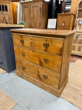 Load image into Gallery viewer, A charming Victorian pine chest of drawers that's built to last! This well-preserved piece features two petite dovetail-jointed drawers positioned above two spacious ones, offering plenty of storage versatility. While it bears the character marks and a minor top crack that come with age, these quirks don't impact functionality one bit. The original key is included, adding to its authentic appeal. Perfect for anyone who loves classic furniture.
Overall Dimensions
91cm wide x 41cm deep x 86cm high
DELIVERY