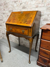 Load image into Gallery viewer, This elegant Queen Anne-style walnut bureau combines timeless design with practical functionality. Featuring a pull-down writing desk and spacious dovetail-jointed drawer, it offers generous storage for any room. The piece is structurally sound and in good overall condition, with one leg requiring minor reinforcement—a straightforward fix with a bracket. A distinguished addition to period or eclectic interiors.
Delivery Available
Overall Dimensions
64cm wide x 45cm deep x 99cm high