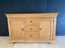 Load image into Gallery viewer, This elegant oak sideboard combines timeless design with practical storage. Featuring three dovetail-jointed drawers and two cupboards, it offers versatile space for dining rooms, hallways, or living areas. Structurally sound with minor surface marks that should polish out easily, it's ready to enhance any home with natural wood character and functionality.
Delivery Available
Overall Dimensions
137cm wide x 46cm deep x 86cm high