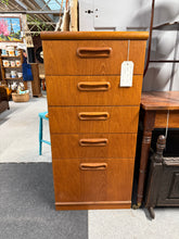 Load image into Gallery viewer, Embrace vintage elegance with this remarkable teak tallboy, a genuine 1960s creation from Singapore. Five spacious drawers provide practical storage solutions while the authentic teak construction radiates warmth and sophistication. Perfect for those seeking to infuse their space with timeless mid-century charm and quality craftsmanship.
Delivery Available
Overall Dimensions
50cm wide x 42cm deep x 107cm high 