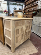 Load image into Gallery viewer, This sweet small sideboard has been stripped back to its natural state so may need a coat of wax for protection. It has two short drawers over a double cupboard for storage. Good overall condition with only minor marks.
Delivery Available
Overall Dimensions
92cm wide x 41cm deep x 82cm high