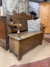 Load image into Gallery viewer, This carved oak settle combines timeless elegance with practical storage. Structurally sound with authentic patina from age and use, it features a lift-up seat concealing generous storage space—ideal for hallways, boot rooms, or entryways. Ornate carved detailing makes it a striking focal point that adds character and warmth to any home. A versatile piece that marries form and function.
Delivery Available
Overall Dimensions
107cm wide x 42cm deep x 100cm high 