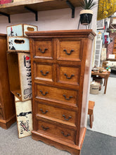 Load image into Gallery viewer, Characterful mango wood tallboy blending rustic charm with practical storage. This pre-loved piece showcases authentic patina and natural wear that enhance its vintage character. Seven drawers—four compact upper and three spacious lower—offer flexible organisation for any room. Solid construction built to last.
Delivery Available
Overall Dimensions
55cm wide x 30cm deep x 111cm high