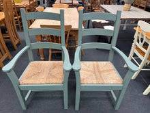 Load image into Gallery viewer, This charming pair of sage green chunky pine carvers are sturdy and well-maintained. They show some signs of use but only minor marks, nothing significant at all.
Delivery Available
Overall Dimensions
approx : 66.5cm wide x 54cm deep x 112cm high