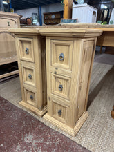 Load image into Gallery viewer, A beautiful pair of stripped pine bedside tables, restored to their natural wood finish. Each unit features three practical drawers for convenient storage. Structurally sound and ready to use, though a protective coat of wax is recommended to enhance and preserve the wood. Ideal for adding warmth and character to any bedroom.
Delivery Available
Overall Dimensions
32.5cm wide x 29cm deep x 74cm high
