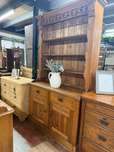 Load image into Gallery viewer, A charming vintage pine dresser with authentic character. Structurally sound and in good overall condition, this piece features a practical open shelving top with 3 shelves, complemented by 2 dovetail-jointed drawers and a lower double cupboard for generous storage. The gentle patina and minor marks tell the story of its age, adding warmth to any room. Disassembles into 2 sections for convenient transport and placement.
Delivery Available
Overall Dimensions
125cm wide at the top
121cm wide x 50cm deep x