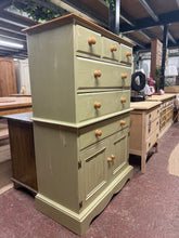 Load image into Gallery viewer, Solid pine storage piece in a charming green finish with distressed detailing. Structurally sound and in good overall condition, showing signs of age and use that add to its character. Features practical storage with three short dovetail-jointed drawers, three long drawers, and one cupboard section. Perfect for adding vintage charm and functional storage to any room.
Delivery Available
Overall Dimensions
92cm wide x 46cm deep x 138.5cm high