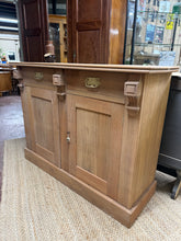 Load image into Gallery viewer, A timeless mahogany sideboard with solid construction and dovetail-jointed drawers. The stripped finish offers an authentic character and welcomes personalisation with wax or oil—perfect for those who appreciate vintage pieces. Features two short drawers above a lockable double cupboard. Minor surface marks are present.
Delivery Available
Overall Dimensions
122cm wide x 43cm deep x 93cm high
