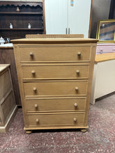 Load image into Gallery viewer, Discover the timeless appeal of this magnificent oak chest of drawers, lovingly restored to showcase its natural beauty. Featuring five generously proportioned drawers with traditional dovetail joinery, it offers exceptional storage capacity for any room. The bare wood finish presents an exciting opportunity to personalise with your choice of wax or stain, allowing you to create a piece that perfectly complements your home's character and style.
Overall Dimensions
77cm wide x 47cm deep x 110cm high / 115c