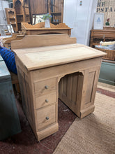 Load image into Gallery viewer, Discover the timeless appeal of authentic wood with this beautifully stripped oak desk. Revealing the grain's natural character, it's ready for your personal finishing touch—a protective wax coat will enhance its rustic charm. Cleverly designed with a lift-top storage compartment, a single cupboard, and three compact drawers, this piece combines classic aesthetics with practical organisation.
Overall Dimensions
81cm wide x 49cm deep x 94cm high
DELIVERY AVAILABLE
For our other items see our websit