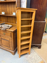 Load image into Gallery viewer, A charming oak bookcase that brings warmth and character to any room. This narrow design fits perfectly into compact spaces while offering reliable storage for your favourite books and treasures. It has a few marks but nothing major at all.
Delivery Available
Overall Dimensions
40cm wide x 19cm deep x 126.5cm high 