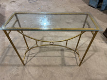 Load image into Gallery viewer, This elegant console table combines a lustrous gold-finished metal base with a removable glass surface, making maintenance effortless. The piece bears subtle signs of use that add authentic charm while maintaining structural integrity. Ideal for entryways or living rooms, it delivers both visual sophistication and practical everyday performance.
Delivery Available
Overall Dimensions
105cm wide x 45cm deep x 90cm high